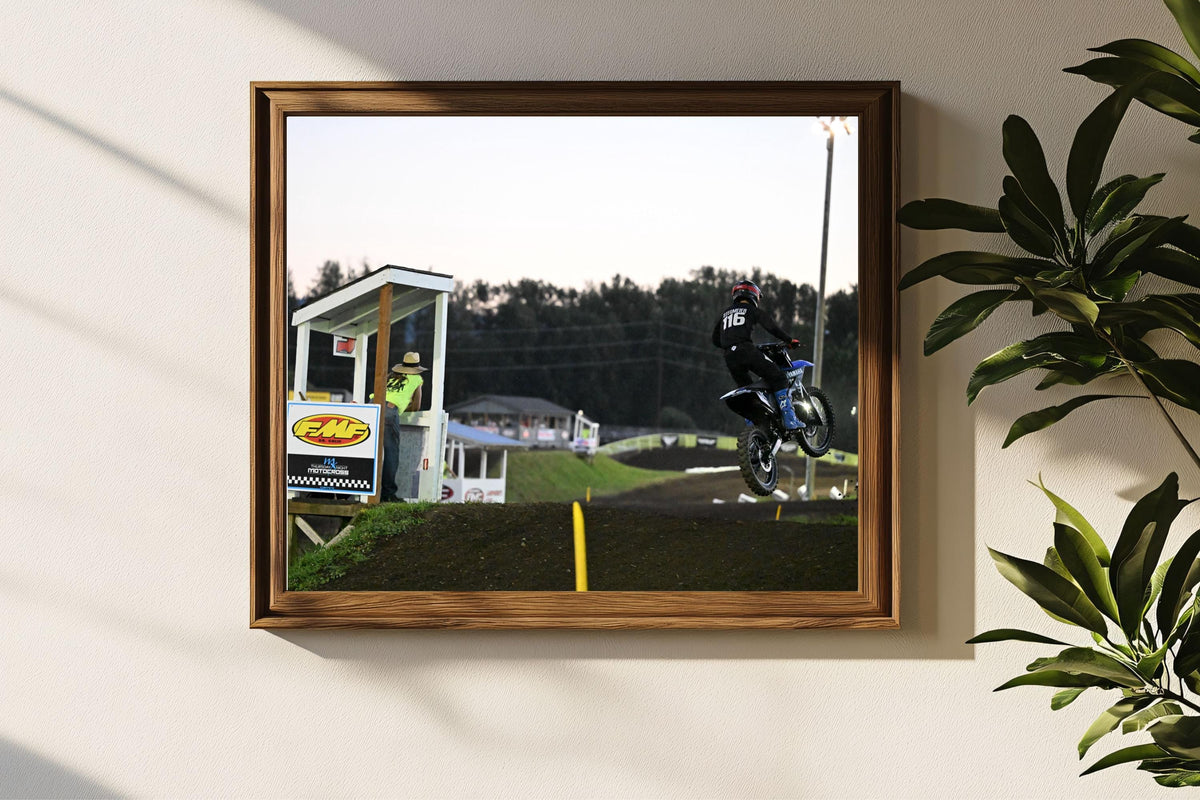 Motocross Motorcyclist makes jump under the lights: Motorsports Photography