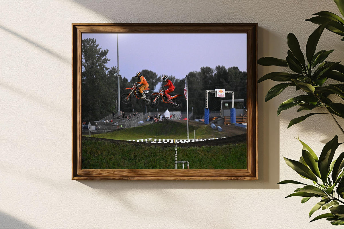 Motorcyclists racing while flying through the air: Motorsports Photography
