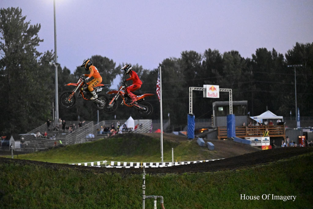 Motorcyclists racing while flying through the air: Motorsports Photography